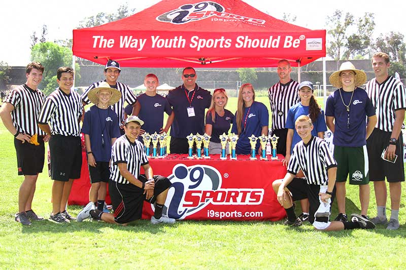 i9 Sports staff at red canopy on game day